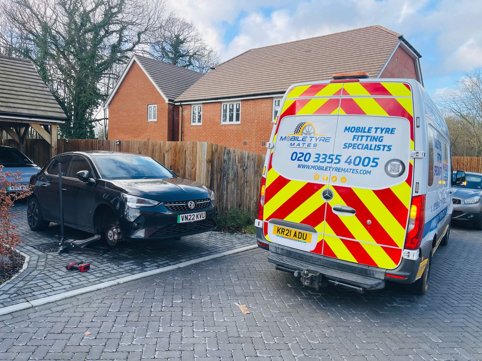 Tyre Mates van on a driveway alongside a car on a jack